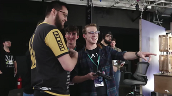 Deep Cut driver Max Morningstar (right, gesturing) points out the debris from Deep Cut to Abomination driver Peter Garnache (left, in yellow) following their match in the January 2023 event. Deep Cut builder Liam Drew (center) and BattleBots finalist Mike Jeffries (far left) can also be seen.